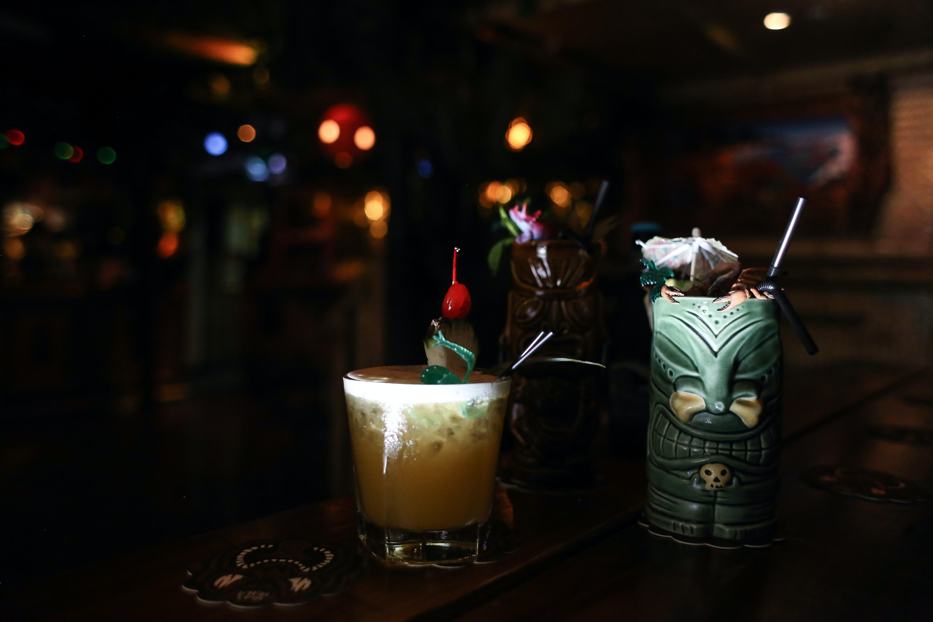 Dark tiki bar with cocktails